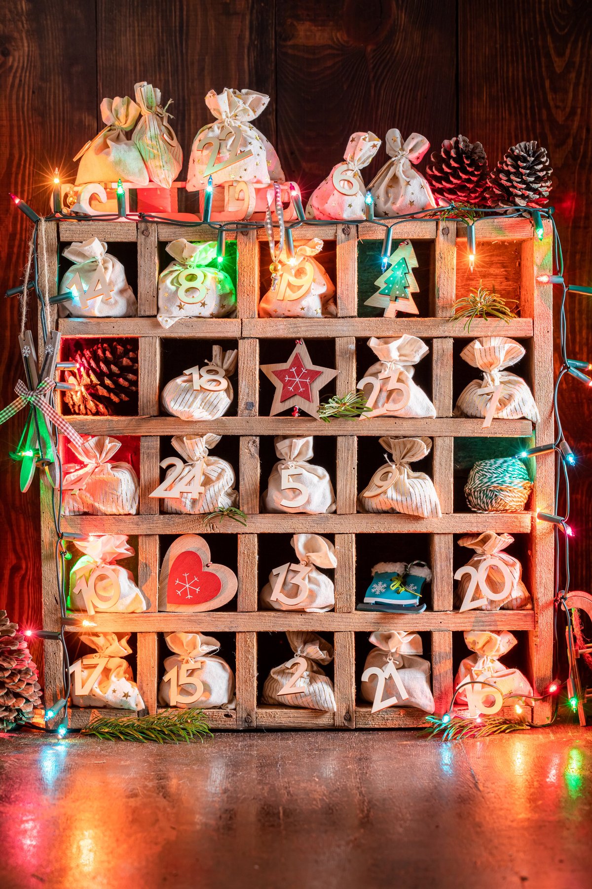 A unique handmade advent calendar made of bags and string on a dark background